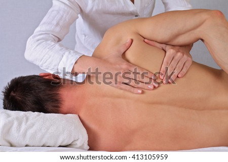 Chiropractic, osteopathy, dorsal manipulation. Therapist  doing healing treatment on man's back . Alternative medicine, pain relief concept