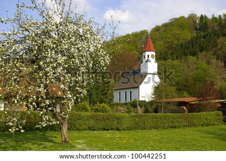 Village church - Some small church of a small German village in spring with an orchard in the foreground.