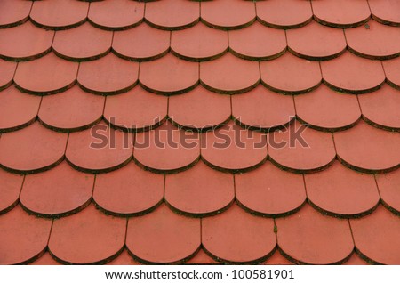 Roofing tiles background - Red roof tiles arranged like scales make an excellent background.