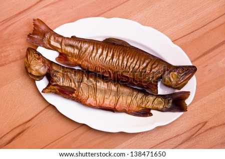 Smoked Fish On A Dish - Two smoked fish (Savelinus) on a white porcelain dish on beechwood.