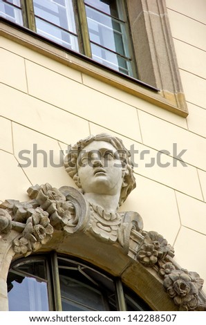 Woman\'s Face - Head of a lady on a Grunderzeit style facade on Unter-den-Linden Street in Berlin, Germany.