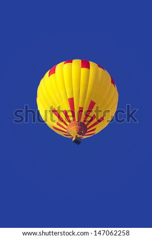 Hot-Air Balloon - Hot-air balloon drifts under blue skies.