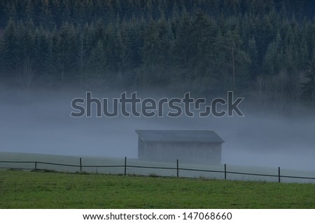 Foggy Countryside - Fog crawls across the land, over meadows, woods and buildings.