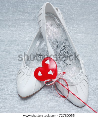 stock photo wedding shoes with red heart on silver background