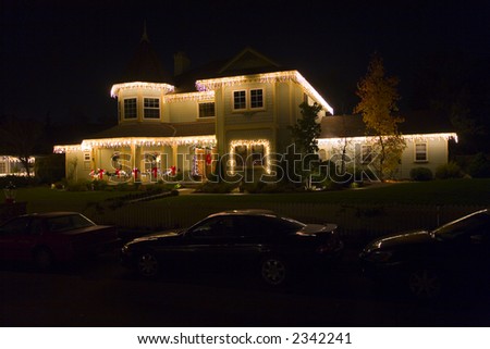 Traditional home lit with Christmas lights...