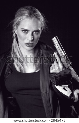 Shot of a blond woman with a pistol and a leather jacket