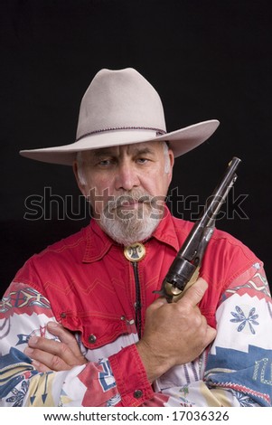Shot of an older western man with a string tie and white hat.