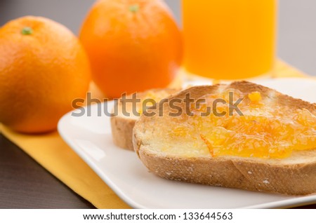 Toast with marmalade and oranges