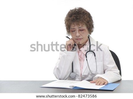 Senior woman doctor writing a file