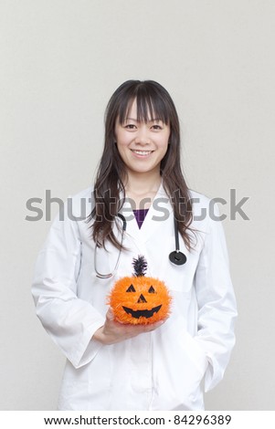 Woman doctor holding a pumpkin