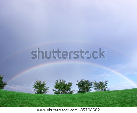 Two rainbows against overcast by fish eye lens.