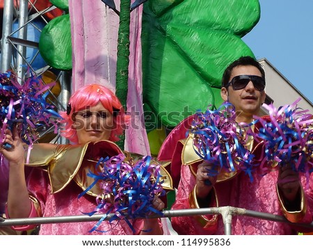VIAREGGIO, ITALY - MARCH 4 An undefined couple in carnival mask at the parades on the promenade during the famous annual Italian Carnival of Viareggio on march 4, 2012 in Viareggio, Italy