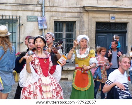 AVIGNON, FRANCE - JULY 17: Unidentified theater actors perform in a square, to advertise their theater show, during annual Avignon Theater Festival in Avignon, France on July 17, 2011.