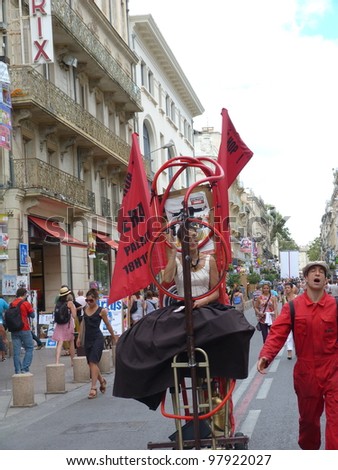 AVIGNON, FRANCE - JULY 18: Unidentified actors perform in the street, to advertise their theater show, during the annual Avignon Theater Festival in Avignon, France on July 18, 2011.