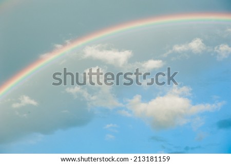 Bright rainbow in the sky with clouds