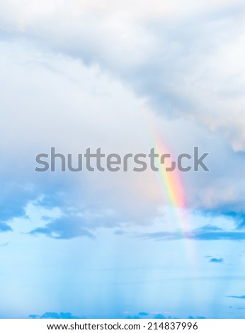 Bright rainbow in the sky with clouds