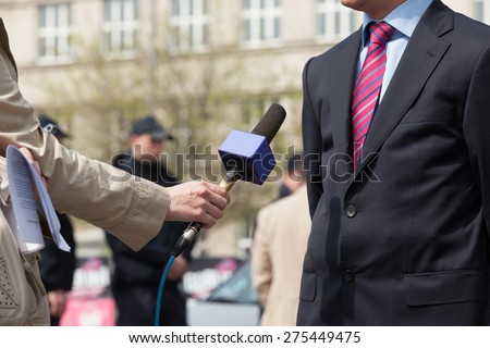 Journalist making media interview with businessman