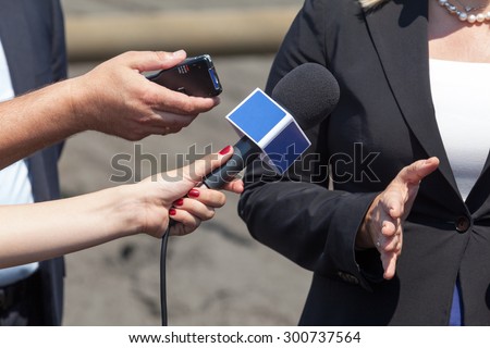 Journalists making interview with business woman