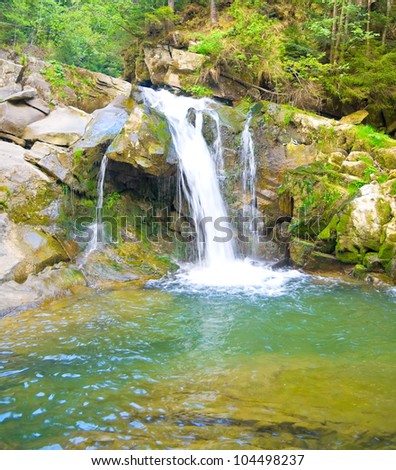 waterfall on a mountain river in the spring