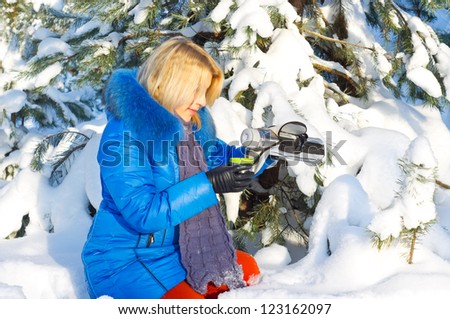 beautiful girl with thermos and cup hot tea in frosty winter day