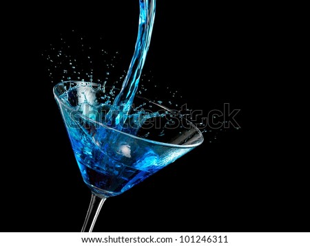 Blue cocktail pouring in a martini glass