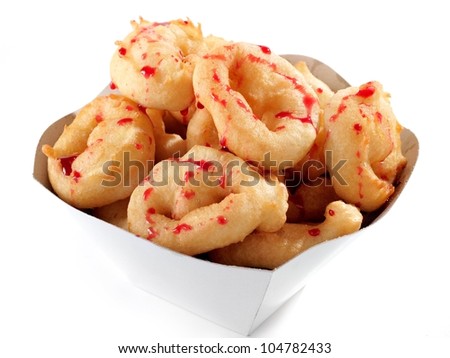 Donuts with red syrup in a carton