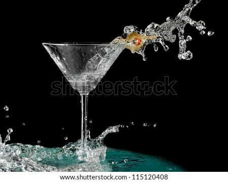Cocktail with a olive splash in martini glass