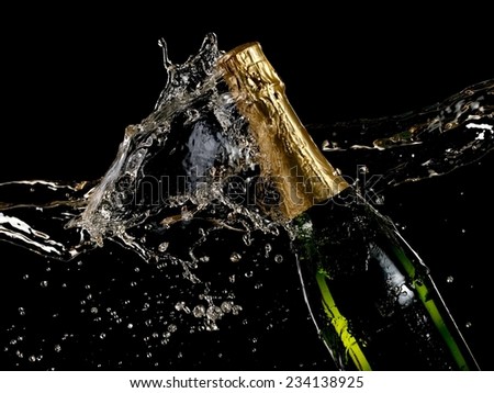 Champagne bottle splash with drops