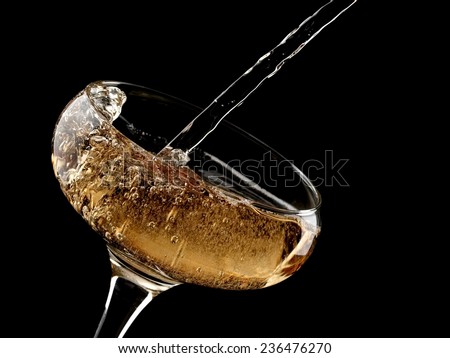 Champagne pouring in a old fashion glass, close up