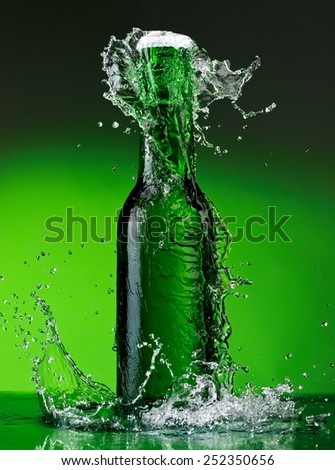 Green beer bottle splash