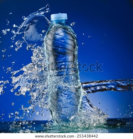 Small water bottle splash on blue background