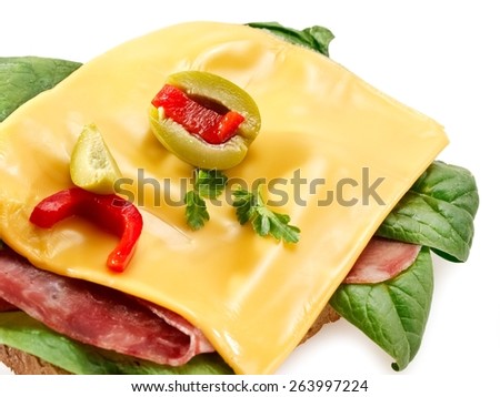 Toast sandwich with cheddar cheese, ham and spinach, close up