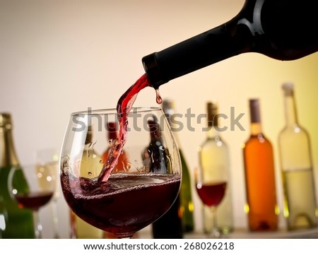 Red wine pouring into a glass from a bottle