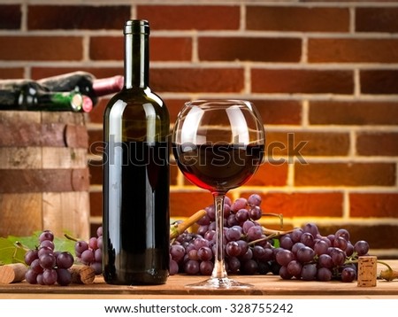 Red wine with grapes in a winery