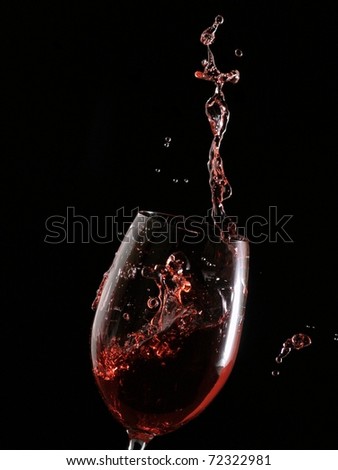 Red wine splash with knots on black background