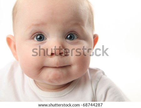 stock photo Closeup portrait of an adorable baby sucking lips with blue