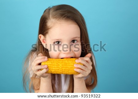 Funny Portrait of a young girl with lemon slices over her eyes on a blue studio background