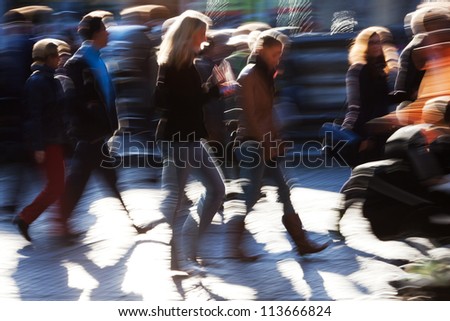 picture of the walking crowd in the city shown in motion blur