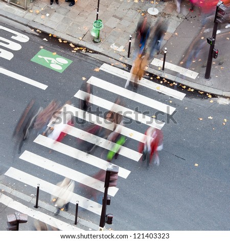 people crossing the city street on the zebra crossing