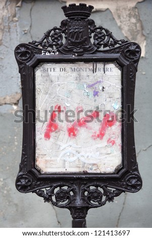 antique wrought iron billboard with a bleached map of Montmartre in Paris
