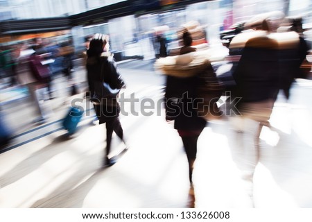 traveling people in motion blur at the railway station