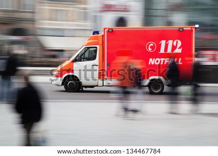 motion blur picture of a driving ambulance vehicle in the city