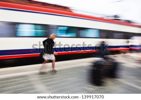 urgent woman at the train station in motion blur