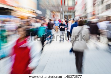 picture of moving crowd in the pedestrian area of the city with zoom effect
