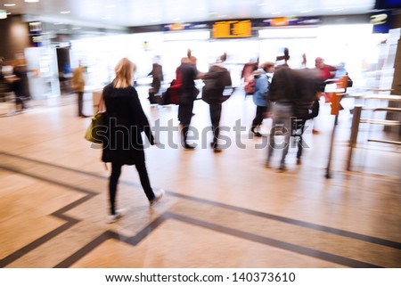 picture in motion blur of traveling people in an underpass of a railway station