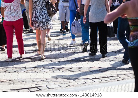 crowd of unrecognizable people walking on the shopping road