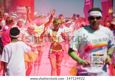 COLOGNE, GERMANY - JULY 23: crowds of unidentified people at the Color Run on July 23, 2013 in Cologne, Germany. The Color Run is a worldwide hosted fun race with about 9000 competitors in Cologne.