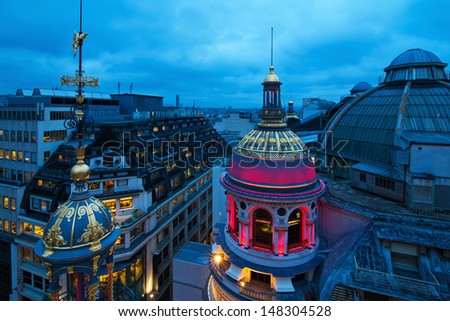PARIS - NOVEMBER 19: colorful illuminated domes of the famous emporium Printemps at night on November 19, 2012 in Paris. The building is famous for the Jugendstil glass dome from 1923.