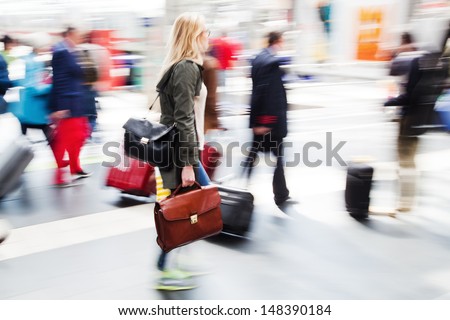 traveling people at the railway station in motion blur