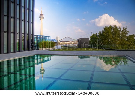 DUSSELDORF, GERMANY - JUNE 11: the media harbour with Rhine Tower view from a pool in front of the modern Hyatt Hotel on June 11, 2013 in Dusseldorf.